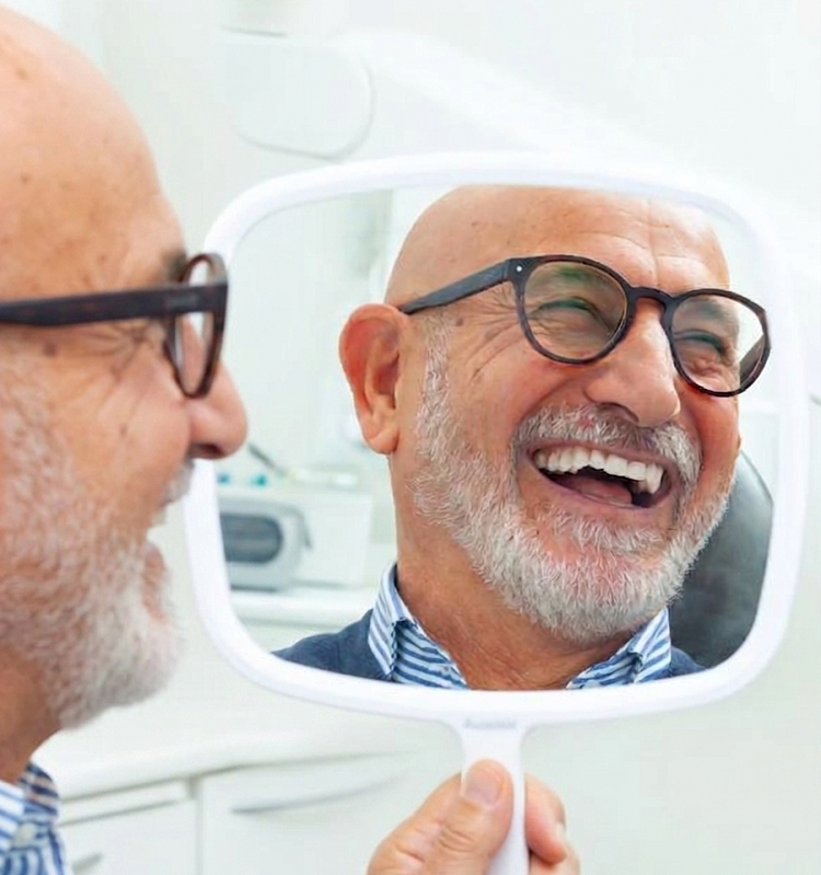 Confident smiling patient after All-on-4 dental implant treatment